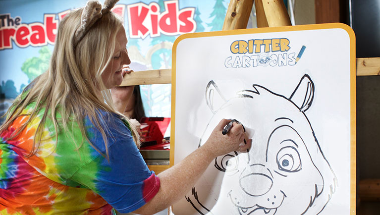 Employee in wolf ears leading a drawing class